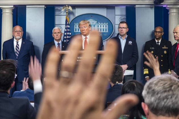 President Donald J. Trump, surrounded by members of the White House Coronavirus Task Force, delivers remarks on the pandemic in the press briefing room of the White House in Washington, DC, on Sunday, March 22, 2020. Cases of the virus have surpassed 32,000 in the United States with most major cities having some sort of lock down or restrictions on large gatherings and public spaces.  WAX20200322106 JIMxLOxSCALZO