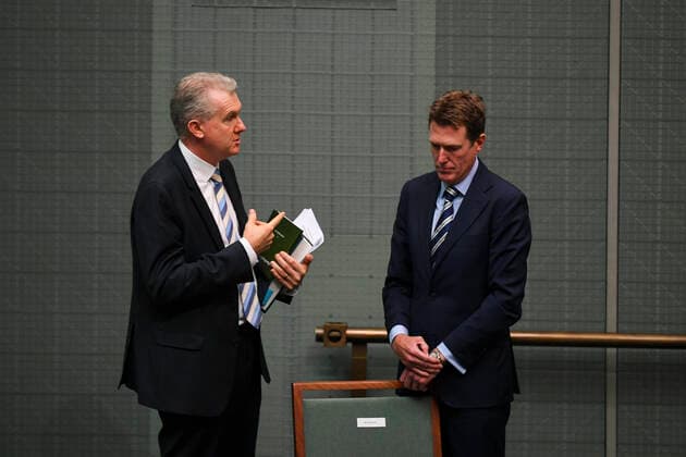 CORONAVIRUS LEGISLATION PARLIAMENT, The manager of Opposition Business Tony Burke (left) speaks to the leader of the House Christian Porter during parliamentary sitting under rules of social distancing in the House of Representatives at Parliament House in Canberra, Monday, March 23, 2020. ( NO ARCHIVING, EDITORIAL USE ONLY, NO USE IN BOOKS WITHOUT CONSENT CANBERRA ACT AUSTRALIA  Copyright: xLUKASxCOCHx 20200323001458844436