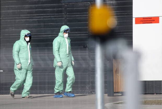 MOSCOW, RUSSIA - MARCH 23, 2020: Employees wearing chemical protection suits seen at the Novomoskovsky multipurpose medical center. Patients suspected of the COVID-19 coronavirus infection and passengers with acute respiratory viral infection (ARVI) symptoms arriving from countries with unfavorable epidemiological situation are sent to the facility. Vyacheslav Prokofyev TASS  TS0D3244