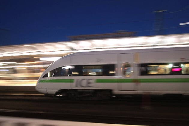 ICE 3 der DB Deutsche n Bahn mit grün em Band bei der Abfahrt vom Hauptbahnhof Frankfurt in der Abenddämmerung, Hessen, Deutschland