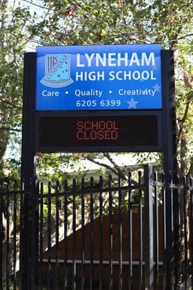 (200323) -- CANBERRA, March 23, 2020 -- Photo taken on March 23, 2020 shows Lyneham High School that is shut down after a student was found infected with novel coronavirus in Canberra, Australia. Non-essential venues across Australia have been ordered to close from midday on Monday in order to slow the spread of COVID-19. Prime Minister Scott Morrison on Sunday night announced an escalation of social distancing measures, including the mandatory closure of cinemas, pubs, entertainment venues, indoor sporting venues and so on. Restaurants and cafes will remain open but will only be allowed to offer takeaway and or home delivery services. (Photo by Xinhua) AUSTRALIA-CANBERRA-COVID-19-SOCIAL DISTANCING MEASURES ChuxChen 