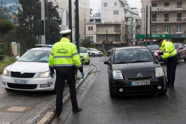 (200323) -- ATHENS, March 23, 2020 -- Policemen check drivers for special permissions that are needed to be outdoors in Athens, Greece, March 23, 2020. Greece proceeds to a 14-day nationwide lockdown effective from Monday in the context of confinement measures aimed to contain the further spread of the novel coronavirus, the government announced on Sunday. ) GREECE-ATHENS-COVID19-LOCKDOWN MariosxLolos 