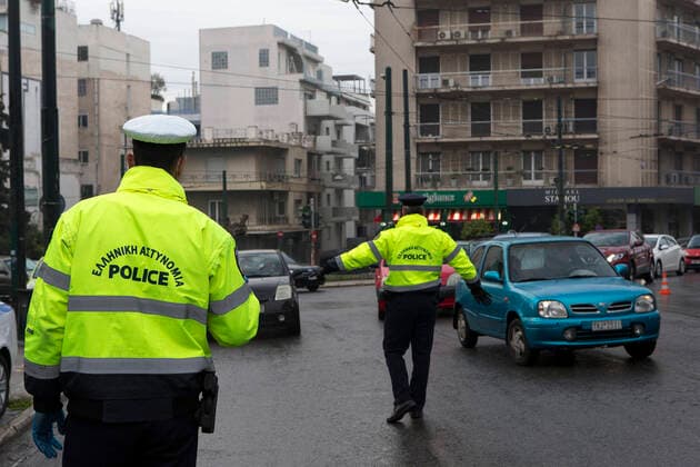 (200323) -- ATHENS, March 23, 2020 -- Policemen check drivers for special permissions that are needed to be outdoor in Athens, Greece, March 23, 2020. Greece proceeds to a 14-day nationwide lockdown effective from Monday in the context of confinement measures aimed to contain the further spread of the novel coronavirus, the government announced on Sunday. ) GREECE-ATHENS-COVID19-LOCKDOWN MariosxLolos 