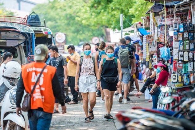 (200323) -- VIENTIANE, March 23, 2020 -- Foreign visitors wearing face masks are seen on the street in Vientiane, Laos, March 23, 2020. Lao people have taken preventive measures against the COVID-19, despite there being no confirmed case of the virus infection in Laos. (Photo by Kaikeo Saiyasane Xinhua) LAOS-VIENTIANE-COVID19-DAILY LIFE ZhangxJianhua 