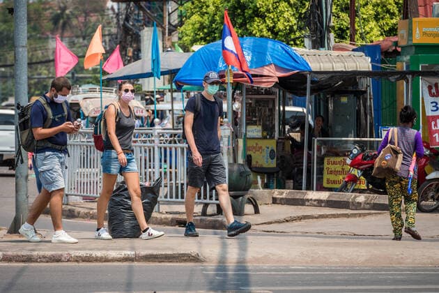 (200323) -- VIENTIANE, March 23, 2020 -- Foreign visitors wearing face masks are seen on the street in Vientiane, Laos, March 23, 2020. Lao people have taken preventive measures against the COVID-19, despite there being no confirmed case of the virus infection in Laos. (Photo by Kaikeo Saiyasane Xinhua) LAOS-VIENTIANE-COVID19-DAILY LIFE ZhangxJianhua 