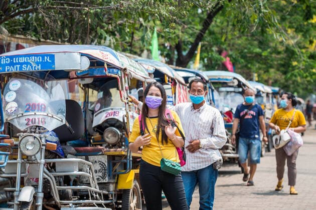 (200323) -- VIENTIANE, March 23, 2020 -- People wearing face masks are seen on the street in Vientiane, Laos, March 23, 2020. Lao people have taken preventive measures against the COVID-19, despite there being no confirmed case of the virus infection in Laos. (Photo by Kaikeo Saiyasane Xinhua) LAOS-VIENTIANE-COVID19-DAILY LIFE ZhangxJianhua 