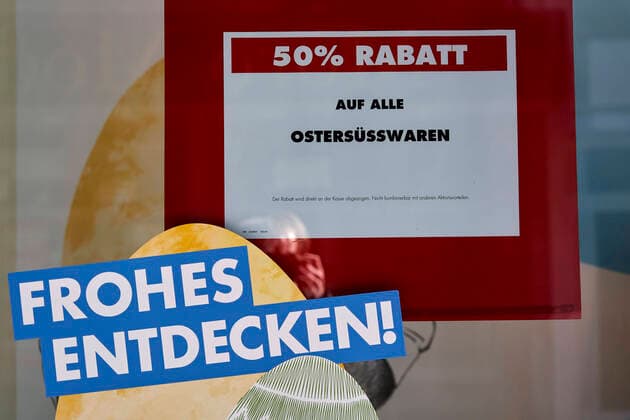 Coronavirus - Koblenz 23.03.2020, Rheinland-Pfalz, Koblenz: SALE - 50 Prozent Rabatt auf alle Ostersüsswaren, ist auf einem Ausgang eines geschlossenen Grossgeschäftes zu Lesen. Die Stadt Koblenz ist weitgehend Menschen- und Fahrzeugleer, die die neuen Regeln greifen seit Montag und dienen der Eindämmung der Corona-Pandemie.