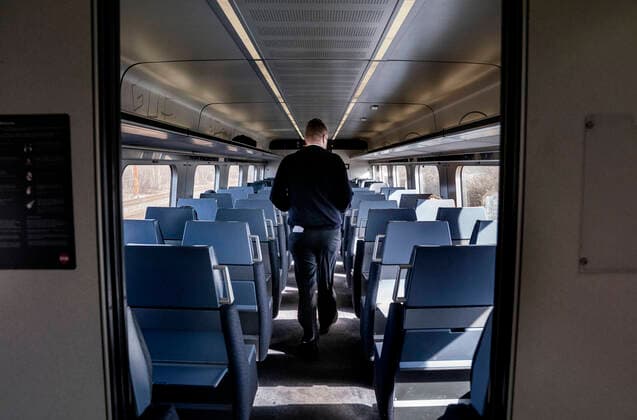 Togfoerer Soeren Juhl Varnaes passerer gennem sit stort set tomme IC-tog efter stop paa Hoeje Taastrup Station, mandag den 23. marts 2020. Langt faerre passagerer koerer med togene paa grund af coronavirus-pandemien, derfor begynder DSB fra mandag at koere efter en reduceret koereplan. . , Copenhagen Denmark