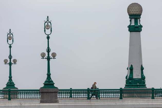 March 23, 2020, San Sebastian, Spain: A woman wearing a face mask as a precaution against the spread of Coronavirus walks along the bridge..Spain registers more than 33,000 cases of coronavirus which means an increase of around 16% of people infected by Covid 19. In addition, the number of people who died from the coronavirus is 2,182 that is 462 more than the day before, which makes Monday 23rd the worst day of the crisis in terms of deaths. San Sebastian Spain - ZUMAs197 20200323_zaa_s197_037 Copyright: xJavixJuliox