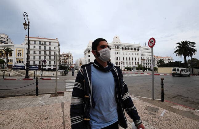 COVID-19 Algeria , Algiers , March 23, 2020 An Algerian man wears a mask in Algiers a street , Monday, March 23, 2020.Algeria reported a new death from COVID-19 .  Copyright: KADRIxMohamed