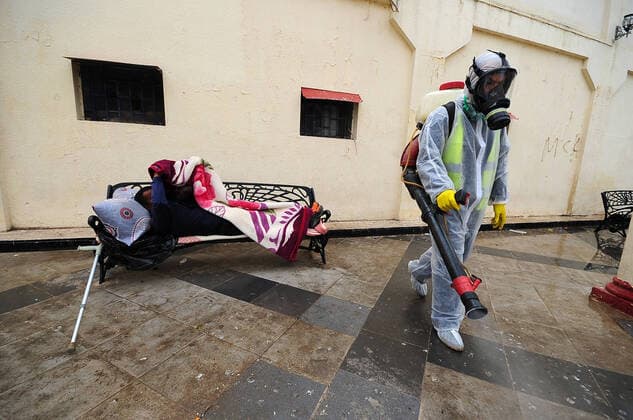 COVID-19 Algeria , Algiers , March 23, 2020 A man disinfects a street of Algiers, Monday, March 23, 2020.Algeria reported a new death from COVID-19 .  Copyright: KADRIxMohamed