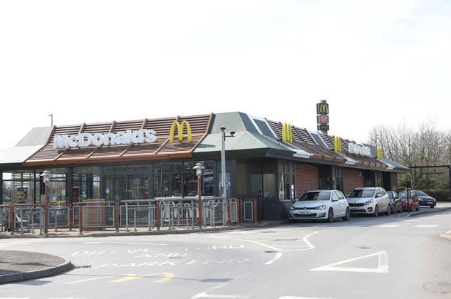 A McDonald s restaurant is busy at the drive-thru as people are only able to get their fast food from it until this evening, when Coronavirus COVID-19 is forcing it close it s doors. McDonald s, Spalding, Lincolnshire, UK, on March 23, 2020 