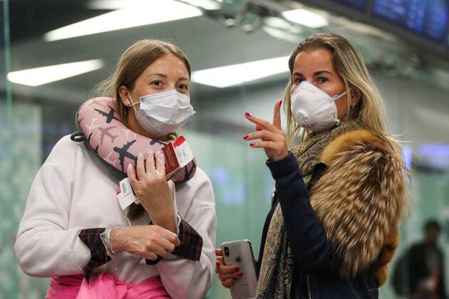MOSCOW, RUSSIA - MARCH 23, 2020: Women wear face masks at Vnukovo International Airport, amid the ongoing COVID-19 pandemic. Mikhail Tereshchenko TASS  TS0D32BE