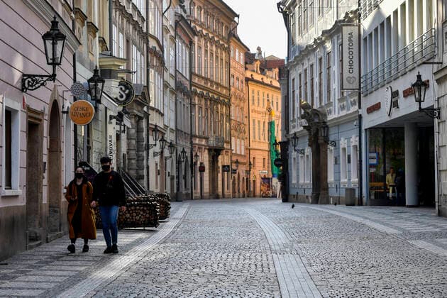 People walk in the deserted Celetna street in Prague, Czech Republic, March 23, 2020. (CTKxPhoto VitxSimanek) CTKPhotoP202003230850401 VIS 008 K