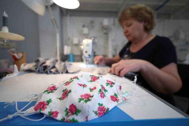 KAZAN, RUSSIA - MARCH 23, 2020: Making reusable face masks at the Chudo Mamy Wonder Moms sewing shop employing mothers of large families and mothers of children with challenges. Yegor Aleyev TASS  TS0D323E