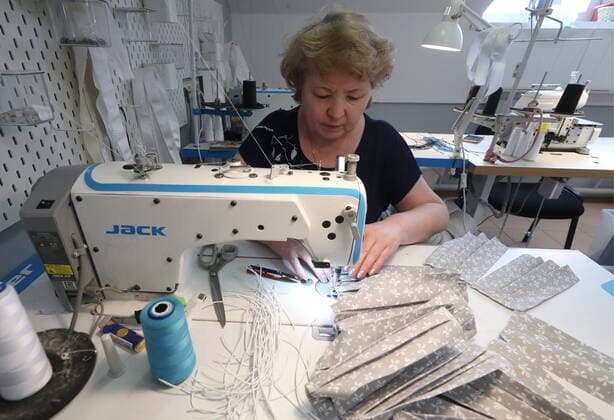 KAZAN, RUSSIA - MARCH 23, 2020: Making reusable face masks at the Chudo Mamy Wonder Moms sewing shop employing mothers of large families and mothers of children with challenges. Yegor Aleyev TASS  TS0D3240