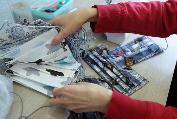 KAZAN, RUSSIA - MARCH 23, 2020: Making reusable face masks at the Chudo Mamy Wonder Moms sewing shop employing mothers of large families and mothers of children with challenges. Yegor Aleyev TASS  TS0D3242