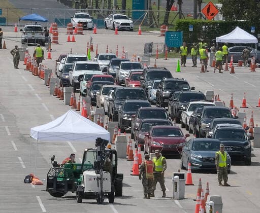 Miami Gardens residents arrive at the testing site to line up in the parking lot of the Hard Rock Stadium on the first day of Coronavirus testing on Monday, March 23, 2020 in Miami Gardens, Florida. This test site is scheduled to handle Miami Gardens area residents over the age of 65 from 7 A.M. to 5 P.M. daily to help identify residents with the Coronavirus.  MIA20200323108 GARYxIxROTHSTEIN