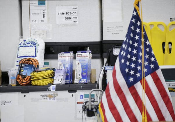 An American flag and medical supplies are on display at the Jacob Javits Convention Center before Gov. Andrew Cuomo speaks with the National Guard on site in New York City on Monday, March 23, 2020. The Javits Center is setting up to be turned into field hospitals to test and possibly treat cases of COVID-19 infections. New York state now accounts for about 1 percent of the coronavirus-related deaths in the world and New York City has more than 12,300 of those cases.  NYP20200323116 JOHNxANGELILLO