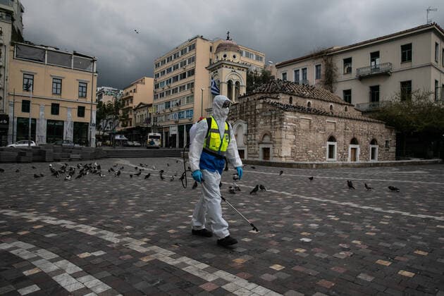 (200323) -- ATHENS, March 23, 2020 -- A worker disinfects a square in historical center of Athens, Greece, on March 23, 2020. City streets across Greece were deserted as the government launched on Monday a 14-day nationwide lockdown in an effort to contain the further spread of the COVID-19. Greece has registered so far 17 deaths linked to COVID-19, up from 15 reported a day earlier and 71 new confirmed cases, bringing the total to 695. (Photo by Xinhua) GREECE- ATHENS-COVID19-LOCKDOWN LEFTERISxPARTSALIS 