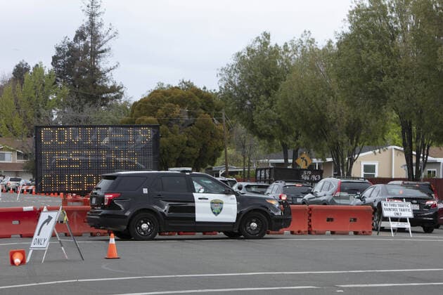 Cars line up for a drive up to be checked by Hayward emergency-medical technicians for symptoms and high temperature at a Coronavirus drive up triage station in Hayward, California on Monday, March 23, 2020. If the individual has symptoms, they are directed to be tested for CIVID-19 at a separate testing tent.  SFP2020032336 PETERxDASILVA