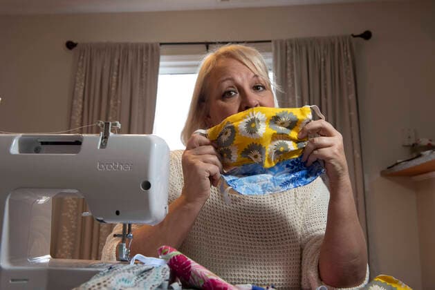 March 21, 2020, Woodstock, GA: Kathy Ahlberg, 53, volunteered to sew several hundred masks from donated materials, to be given to doctors and nurses struggling to stay safe in the midst of the coronavirus crisis. She is one of nearly 450 volunteers in the Atlanta area who donate their skills to produce the fabric masks. Woodstock - ZUMAn03_ 20200321_zaf_n03_003 Copyright: xRobinxRaynex