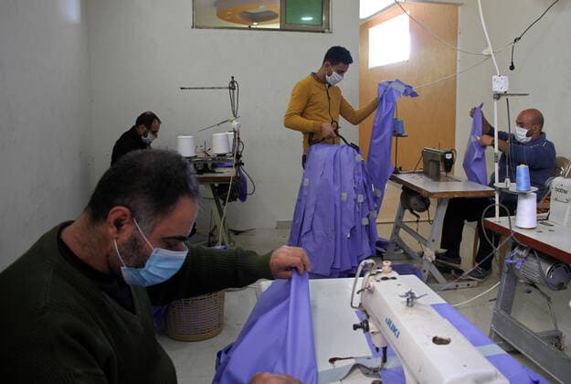 (200323) -- BEIT LAHIA, March 23, 2020 (Xinhua) -- Palestinian workers make protective suits at a factory in the northern Gaza Strip town of Beit Lahia, on March 22, 2020. A Gaza factory, which is located in the coastal enclave town of Beit Lahia, has succeeded in producing protective suits following China s standards. (Photo by Rizek Abdeljawad Xinhua) TO GO WITH Feature: Gaza factory follows China s standards to produce protective suits amid COVID-19 MIDEAST-GAZA-BEIT LAHIA-COVID-19-PROTECTIVE SUITS-PRODUCTION 