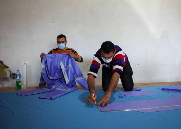 (200323) -- BEIT LAHIA, March 23, 2020 (Xinhua) -- Palestinian workers make protective suits at a factory in the northern Gaza Strip town of Beit Lahia, on March 22, 2020. A Gaza factory, which is located in the coastal enclave town of Beit Lahia, has succeeded in producing protective suits following China s standards. (Photo by Rizek Abdeljawad Xinhua) TO GO WITH Feature: Gaza factory follows China s standards to produce protective suits amid COVID-19 MIDEAST-GAZA-BEIT LAHIA-COVID-19-PROTECTIVE SUITS-PRODUCTION 