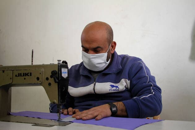 (200323) -- BEIT LAHIA, March 23, 2020 (Xinhua) -- A Palestinian worker makes a protective suit at a factory in the northern Gaza Strip town of Beit Lahia, on March 22, 2020. A Gaza factory, which is located in the coastal enclave town of Beit Lahia, has succeeded in producing protective suits following China s standards. (Photo by Rizek Abdeljawad Xinhua) TO GO WITH Feature: Gaza factory follows China s standards to produce protective suits amid COVID-19 MIDEAST-GAZA-BEIT LAHIA-COVID-19-PROTECTIVE SUITS-PRODUCTION 