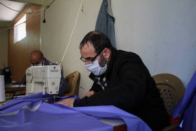 (200323) -- BEIT LAHIA, March 23, 2020 (Xinhua) -- Palestinian workers make protective suits at a factory in the northern Gaza Strip town of Beit Lahia, on March 22, 2020. A Gaza factory, which is located in the coastal enclave town of Beit Lahia, has succeeded in producing protective suits following China s standards. (Photo by Rizek Abdeljawad Xinhua) TO GO WITH Feature: Gaza factory follows China s standards to produce protective suits amid COVID-19 MIDEAST-GAZA-BEIT LAHIA-COVID-19-PROTECTIVE SUITS-PRODUCTION 