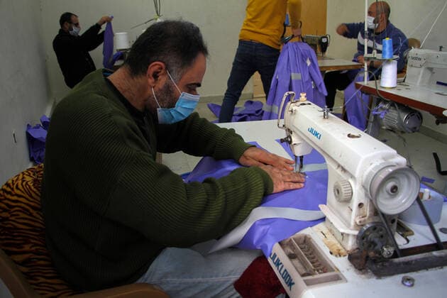 (200323) -- BEIT LAHIA, March 23, 2020 (Xinhua) -- Palestinian workers make protective suits at a factory in the northern Gaza Strip town of Beit Lahia, on March 22, 2020. A Gaza factory, which is located in the coastal enclave town of Beit Lahia, has succeeded in producing protective suits following China s standards. (Photo by Rizek Abdeljawad Xinhua) TO GO WITH Feature: Gaza factory follows China s standards to produce protective suits amid COVID-19 MIDEAST-GAZA-BEIT LAHIA-COVID-19-PROTECTIVE SUITS-PRODUCTION 
