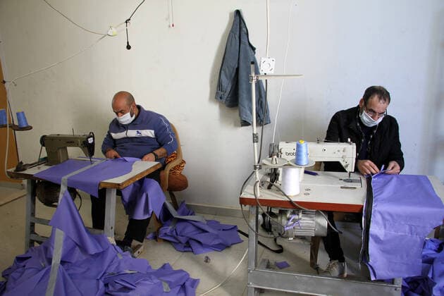 (200323) -- BEIT LAHIA, March 23, 2020 (Xinhua) -- Palestinian workers make protective suits at a factory in the northern Gaza Strip town of Beit Lahia, on March 22, 2020. A Gaza factory, which is located in the coastal enclave town of Beit Lahia, has succeeded in producing protective suits following China s standards. (Photo by Rizek Abdeljawad Xinhua) TO GO WITH Feature: Gaza factory follows China s standards to produce protective suits amid COVID-19 MIDEAST-GAZA-BEIT LAHIA-COVID-19-PROTECTIVE SUITS-PRODUCTION 