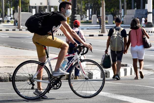 (200324) -- HAVANA, March 24, 2020 (Xinhua) -- A bicyclist wearing a mask is seen on a street in Havana, Cuba, March 23, 2020. Cuban President Miguel Diaz Canel on Monday urged state institutions, private sectors and people to increase control and discipline in an effort to contain the COVID-19 outbreak. (Photo by Joaquin Hernandez Xinhua) CUBA-HAVANA-COVID-19 