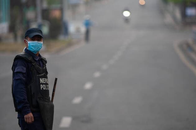 March 24, 2020, Kathmandu, Nepal: A Nepal police officer wearing a protective mask stands on guard on a deserted road during the lock down as a preventive measure against the spread of Coronavirus..Nepal government has decided to lock down the whole country from 24 March till 31 March following a second confirmed COVID-19 case. Kathmandu Nepal - ZUMAs197 20200324_zaa_s197_018 Copyright: xPrabinxRanabhatx