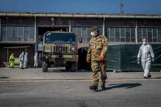 Ponte San Pietro (Bergamo). Military and medical personnel of the Army together with the Carabinieri transport the coffins with the use of six trucks from a depot in Ponte San Pietro due to emergency COVID19 Coronavirus (Carlo Cozzoli Fotogramma, San Pietro bridge - 2020-03-24) p.s. la foto e utilizzabile nel rispetto del contesto in cui e stata scattata, e senza intento diffamatorio del decoro delle persone rappresentate  Copyright: xCarloxCozzolix xFOTOGRAMMAx