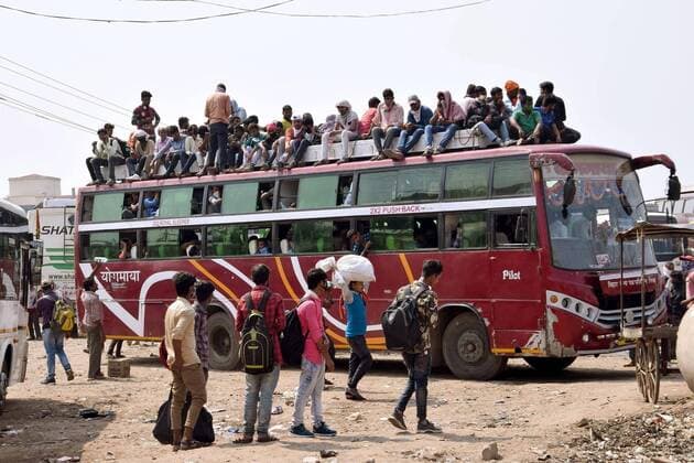 PATNA, INDIA - MARCH 23: Commuters seen atop a overcrowded bus during the first day of lockdown imposed by the state government to curb the spread of coronavirus , on March 23, 2020 in Patna India.(Photo Santosh Kumar Hindustan Times) First day Of Lockdown In Patna