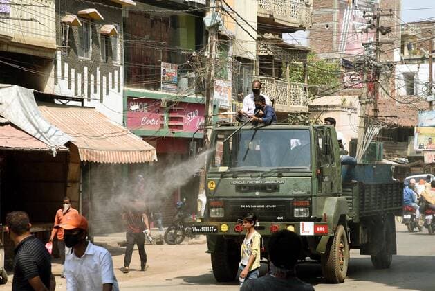 PATNA, INDIA - MARCH 23: A truck sprays disinfectant to sanitize the area at Danapur during a lockdown over the coronavirus , on March 23, 2020 in Patna, India. (Photo Santosh Kumar Hindustan Times) First day Of Lockdown In Patna