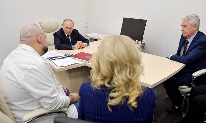 MOSCOW, RUSSIA - MARCH 24, 2020: Chief physician Denis Protsenko (L front) meets with Russia s President Vladimir Putin and Moscow Mayor Sergei Sobyanin (L-R back) on their visit to the Novomoskovsky multipurpose medical center for patients suspected of the COVID-19 coronavirus infection. Alexei Druzhinin Russian Presidential Press and Information Office TASS  TS0D3370