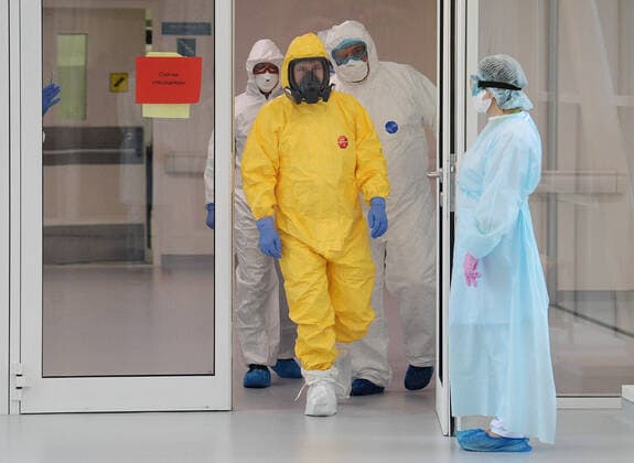 MOSCOW, RUSSIA - MARCH 24, 2020: Russia s President Vladimir Putin wears a yellow protective suit on his visit to the Novomoskovsky multipurpose medical center for patients suspected of the COVID-19 coronavirus infection. Alexei Druzhinin Russian Presidential Press and Information Office TASS  TS0D3373