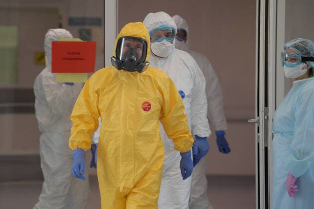 MOSCOW, RUSSIA - MARCH 24, 2020: Russia s President Vladimir Putin wears a yellow protective suit on his visit to the Novomoskovsky multipurpose medical center for patients suspected of the COVID-19 coronavirus infection. Alexei Druzhinin Russian Presidential Press and Information Office TASS  TS0D3374