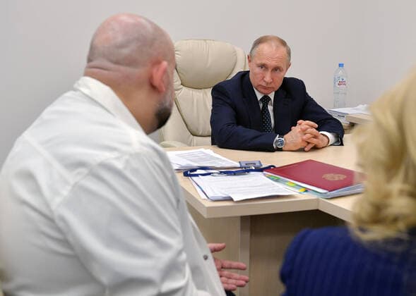 MOSCOW, RUSSIA - MARCH 24, 2020: Russia s President Vladimir Putin (back) meets with chief physician Denis Protsenko on his visit to the Novomoskovsky multipurpose medical center for patients suspected of the COVID-19 coronavirus infection. Alexei Druzhinin Russian Presidential Press and Information Office TASS  TS0D3377