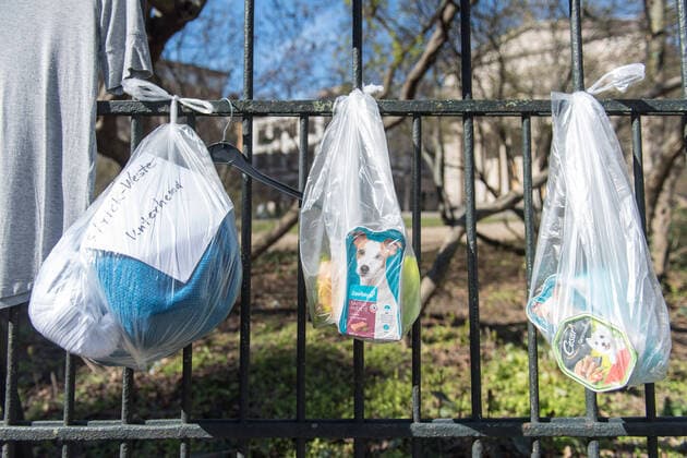 Bekleidung und Hundefutter am Spendenzaun an der Evangelische Kirchengemeinde am Weinberg in Berlin-Mitte (Foto vom 24.03.2020). In ganz Deutschland entstehen derzeit sogenannte Spenden- oder Gabenzaeune fuer Obdachlose. Die Menschen werden dazu aufgerufen, in Plastiktueten verpackte Lebensmittel, Hygieneartikel oder Kleiderspenden an die Zaeune zu haengen, damit sich auf der Strasse lebende oder arme Menschen dort versorgen koennen. Wegen der Corona-Pandemie haben viele soziale Einrichtungen wie Tafeln, Nachtcafes und Suppenkuechen aus Infektionsschutzgruenden mittlerweile geschlossen. (Siehe epd-Meldung vom 24.03.2020) Gabenzaeune fuer Obdachlose in ganz Deutschland