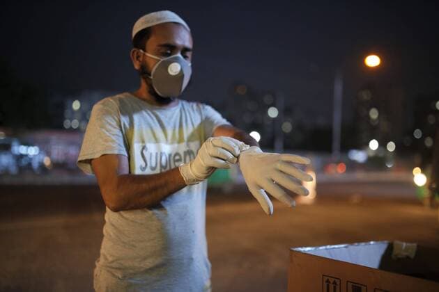 March 24, 2020, Dhaka, Bangladesh: A man wears hand gloves as a preventive measure against the spread of the COVID-19 coronavirus buys from a street vendor at the capital. Dhaka Bangladesh - ZUMAh143 20200324_zap_h143_006 Copyright: xMDxMehedixHasanx