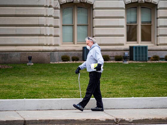 March 24, 2020, Des Moines, Iowa, U.S: A person walks by the county courthouse in downtown Des Moines Tuesday. The city is deserted because many people are choosing to stay home and shelter in place because of the coronavirus. On Tuesday morning, 24 March, Iowa reported over 120 confirmed cases of the Coronavirus (SARS-CoV-2) and COVID-19. Restaurants, bars, movie theaters, places that draw crowds are closed for at least 30 days. The Governor has not ordered shelter in place but several Mayors, including the Mayor of Des Moines, have asked residents to stay in their homes for all but the essential needs. People are being encouraged to practice social distancing and many businesses are requiring or encouraging employees to telecommute. Des Moines U.S. - ZUMAk94_ 20200324_zaf_k94_016 Copyright: xJackxKurtzx