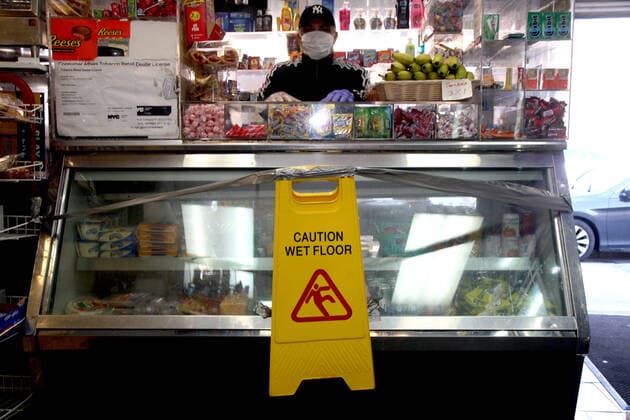 March 24, 2020, New York City, New York, US: Local bodega (mom and pop store) owner takes charge of his personal protection against the coronavirus (COVID-19) by erecting a self-made cautionary barrier, separating his customers and self against the rampaging pandemic in the South Bronx as seen on Tuesday, 25 March 2020. New York City US - ZUMAl135 20200324_zap_l135_008 Copyright: xG.xRonaldxLopezx