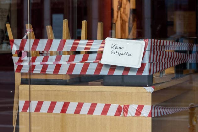 Coronavirus, Eindrücke von den Ausgangsbeschränkungen in Berlin Deutschland, Berlin - 24.03.2020: Im Bild sind mit absperrband umwickelte Stühle in einem Geschäft mit einem Schild keine Sitzplätze zu sehen. Berlin Berlin Deutschland