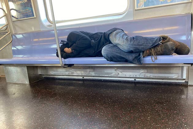 NEW YORK, NY - MARCH 24: New York homeless man sleeps in a train as the coronavirus grows city-wide. The number of cases of homeless people in New York City with COVID-19 reportedly has more than doubled over the weekend. March 24, 2020. Copyright: xRainmakerxPhotosx