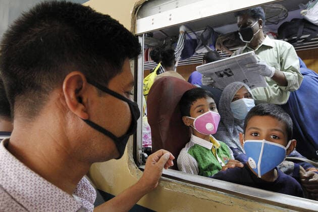 (200324) -- DHAKA, March 24, 2020 (Xinhua) -- People wearing face masks are seen on a train in Dhaka, Bangladesh, on March 24, 2020. The Bangladeshi government on Tuesday announced to restrict public transport across the country till April 4 from March 26 amid efforts to contain the COVID-19 outbreak. The Bangladeshi government on Tuesday reported the fourth death in the country in addition to six more confirmed cases, bringing the total to 39. (Str Xinhua) BANGLADESH-DHAKA-COVID-19-PUBLIC TRANSPORTATION-RESTRICTION 