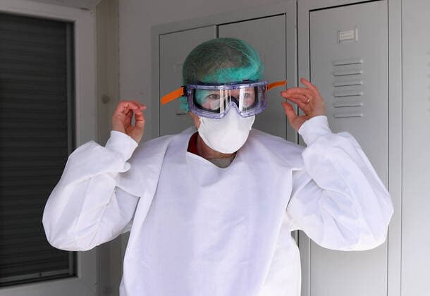 Tuebingen 24.03.2020 Corona: Container Ambulanz Tuebingen, Covid 19 Versorgung auf dem Tuebinger Festplatz. Dr. Julia Martin beim Anlegen der Schutzkleidung fuer die ambulanten Versorgung von Patienten.