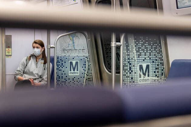 March 24, 2020, Washington, DC, UNITED STATES: A woman passenger wearing a protective mask sits on a Metro in Washington, DC on Tuesday, March 24, 2020. To date the United States has 52,966 Corona Virus cases and 685 deaths. President Donald Trump says he wants the nation opened up and just raring to go by Easter -- a date just more than two weeks away that few health experts believe will be sufficient in containing the spread of coronavirus. Washington UNITED STATES - ZUMAc206 20200324_zap_c206_003 Copyright: xKenxCedenox
